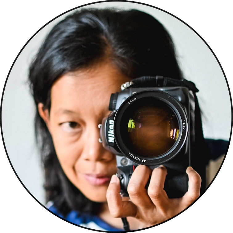 Savitri holding a camera in front of right eye